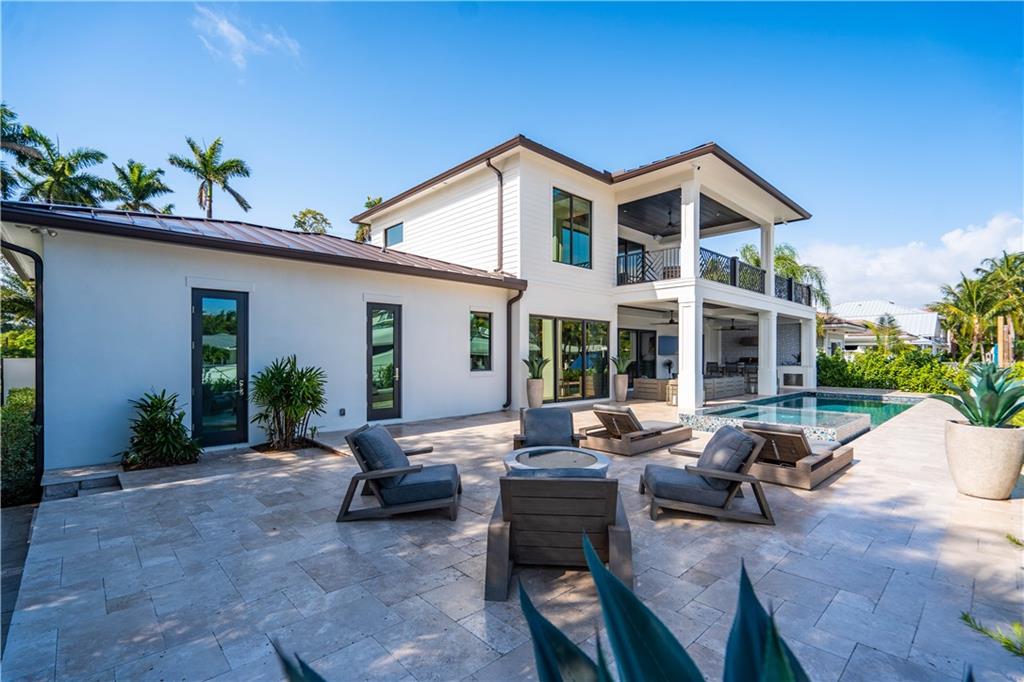 2349 Northeast 24th Street Lighthouse Point, FL 33064 - Photo 64 of 85 a view of a house with backyard sitting area and porch