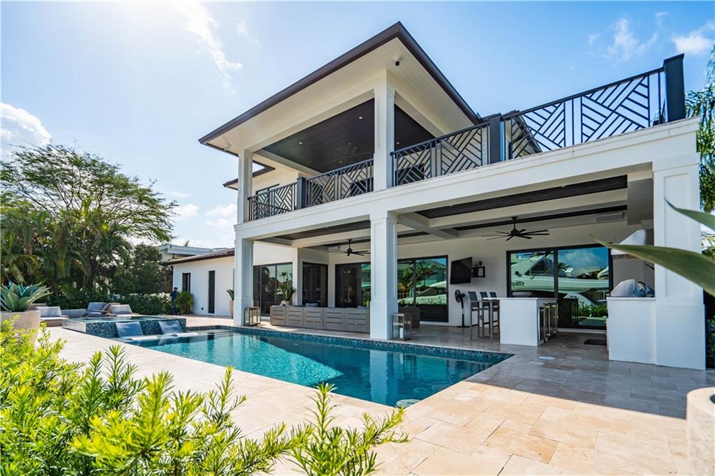 2349 Northeast 24th Street Lighthouse Point, FL 33064 - Photo 65 of 85 a view of a house with swimming pool and sitting area