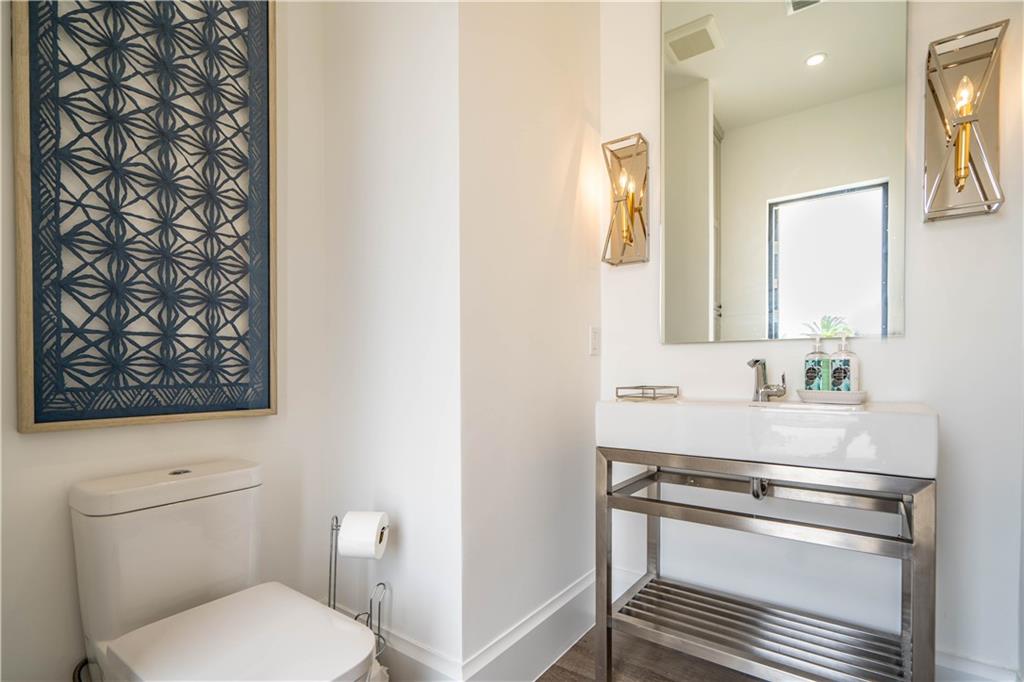 2349 Northeast 24th Street Lighthouse Point, FL 33064 - Photo 85 of 85 a bathroom with a toilet a sink and a mirror