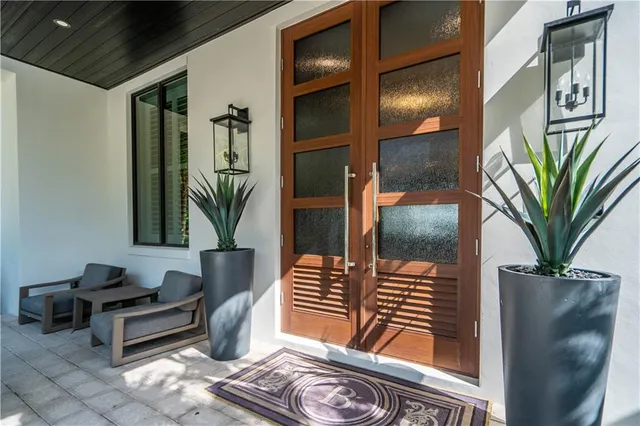 a kitchen with kitchen island granite countertop a dining table chairs refrigerator and sink