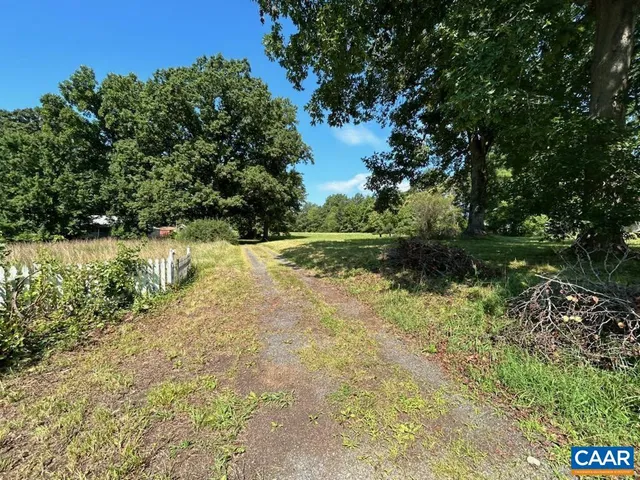 a yard with a house in the background