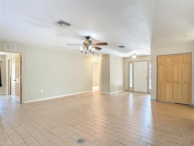 a kitchen with stainless steel appliances granite countertop wooden cabinets a stove a sink a dining table and chairs