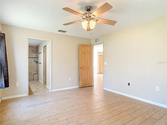 a white toilet sitting next to a shower