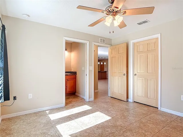 a bedroom with a large bed and a large window