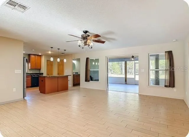 a view of a kitchen with a sink and a refrigerator