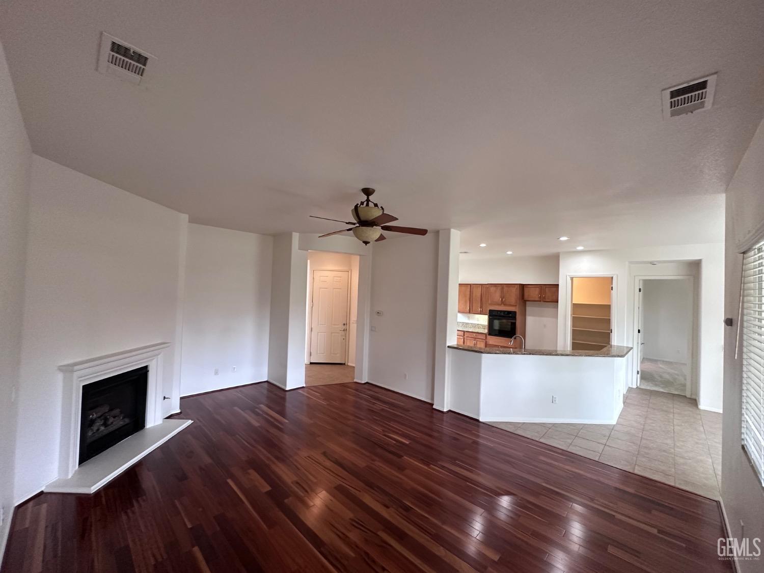 Undisclosed Address Bakersfield, CA 93306 - Photo 43 of 43 a open kitchen view with fireplace and wooden floor