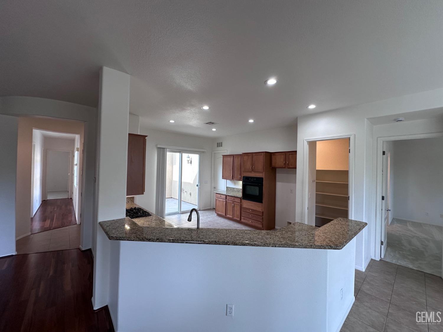 Undisclosed Address Bakersfield, CA 93306 - Photo 15 of 43 a large kitchen with kitchen island a sink stainless steel appliances and cabinets