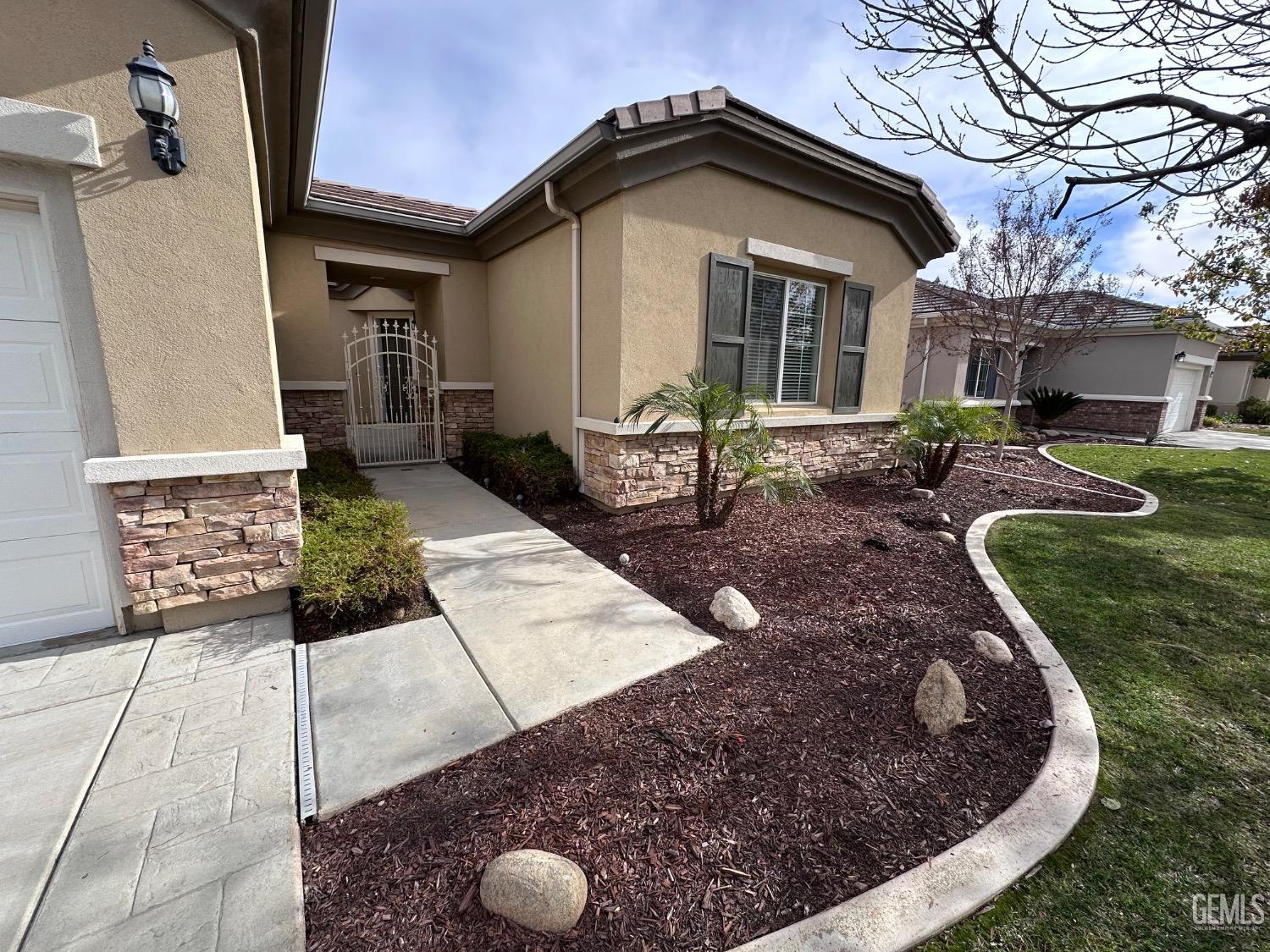 Undisclosed Address Bakersfield, CA 93306 - Photo 2 of 43 a front view of a house with garden