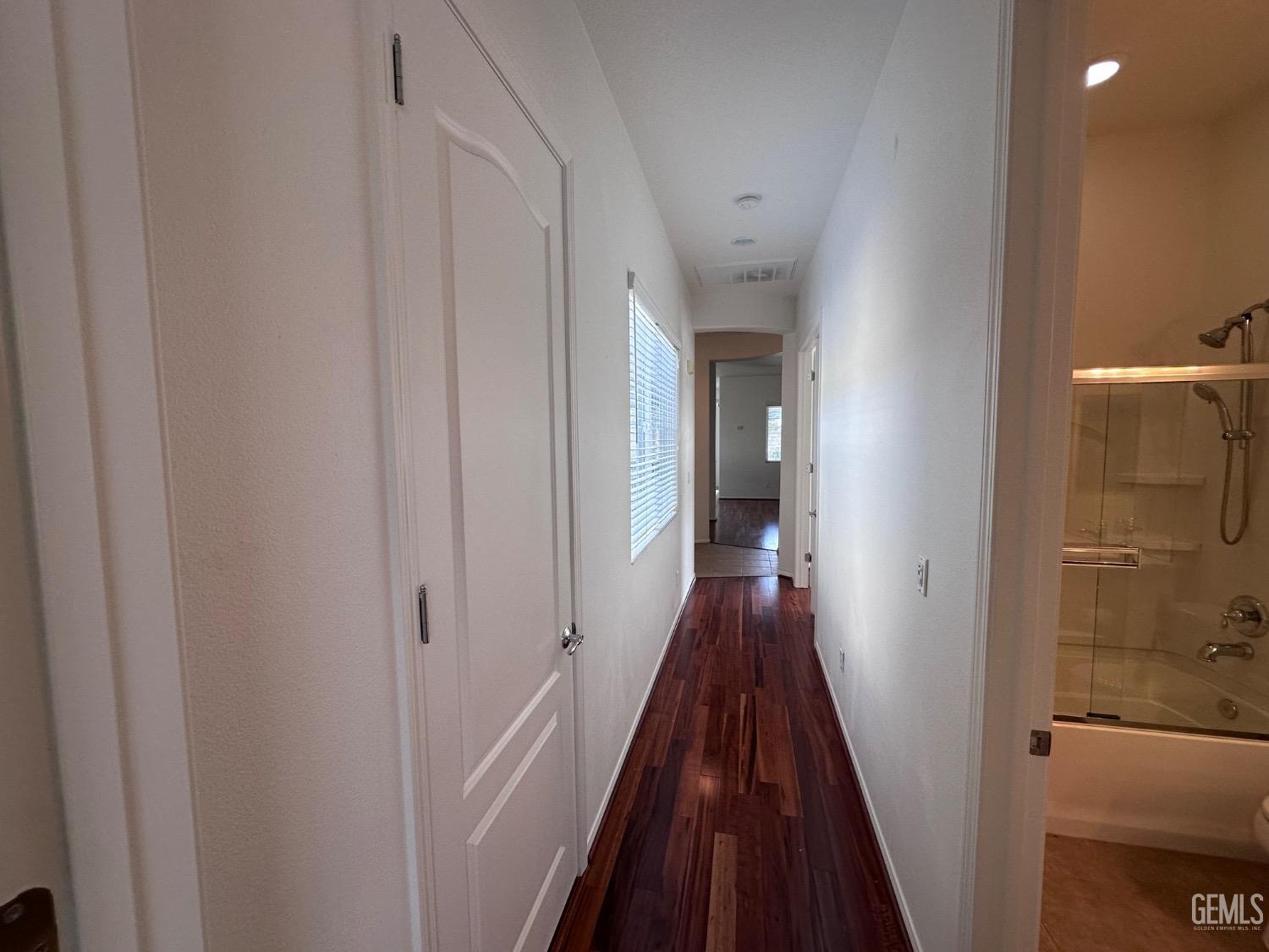 Undisclosed Address Bakersfield, CA 93306 - Photo 25 of 43 a view of a hallway with wooden floor and staircase