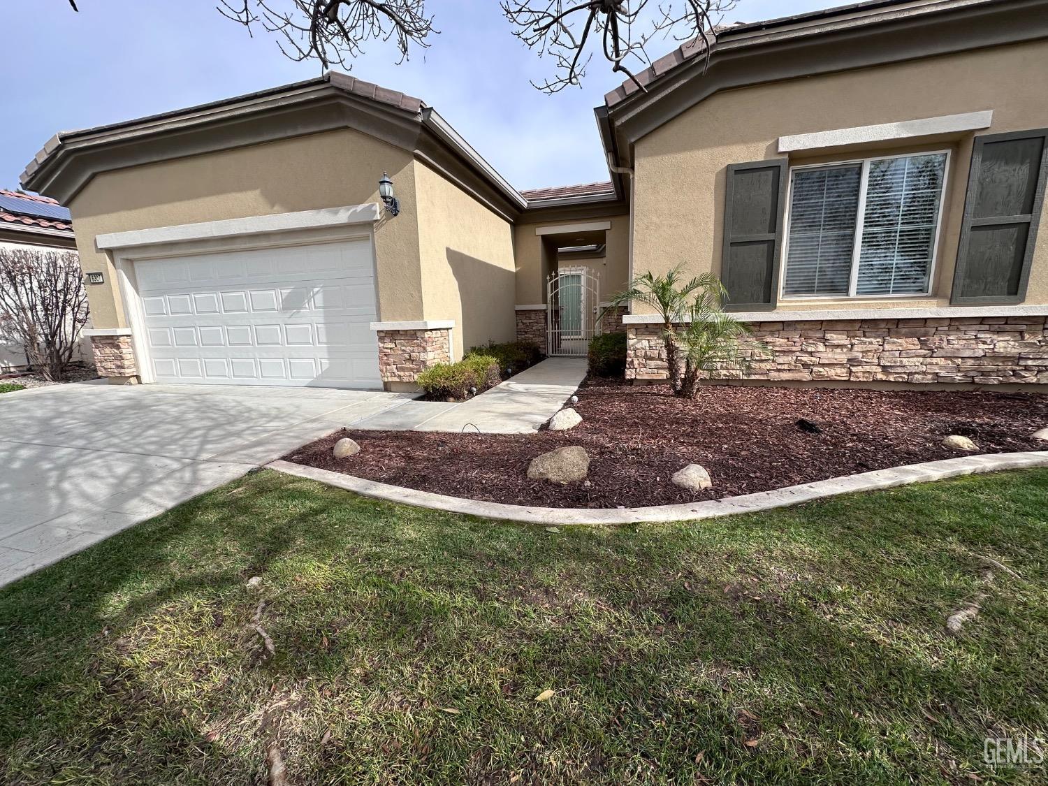 Undisclosed Address Bakersfield, CA 93306 - Photo 3 of 43 a front view of a house with garden