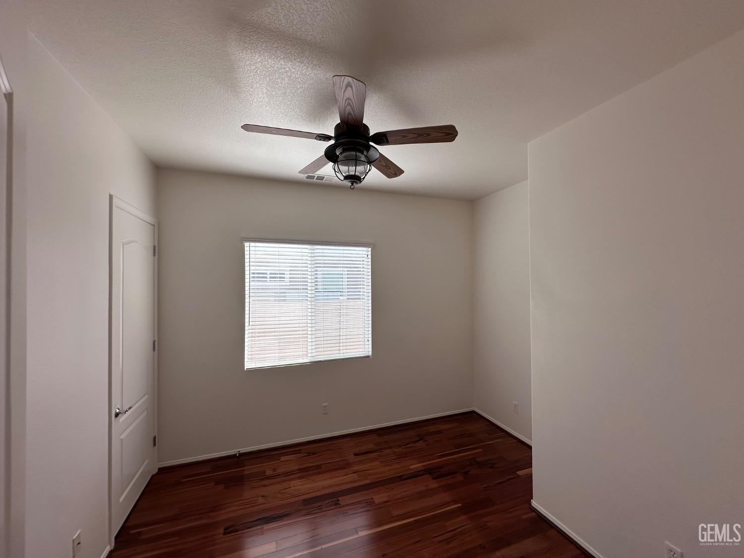 Undisclosed Address Bakersfield, CA 93306 - Photo 31 of 43 a view of room with hardwood floor and ceiling fan