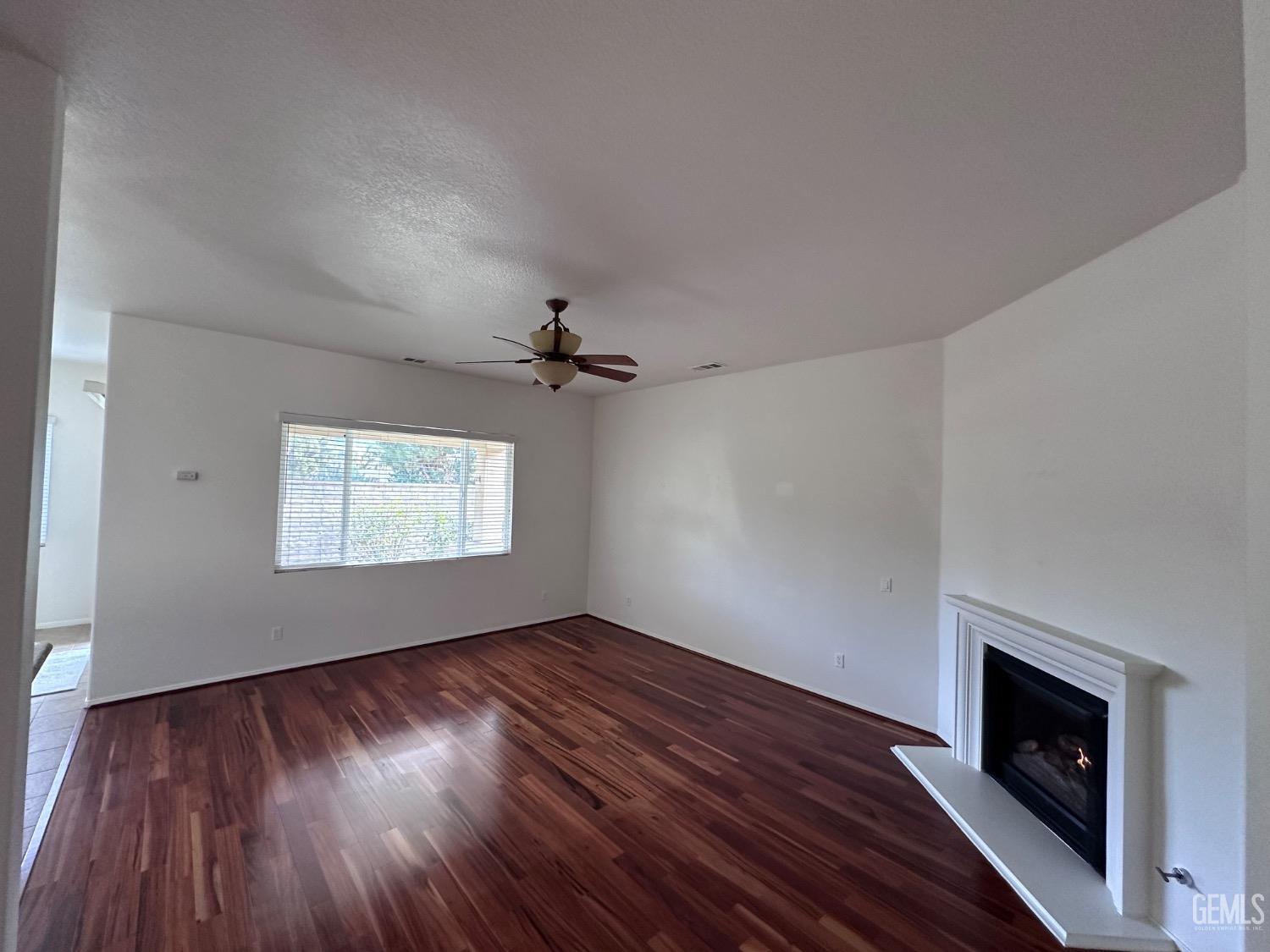 Undisclosed Address Bakersfield, CA 93306 - Photo 32 of 43 a view of empty room with wooden floor and fireplace