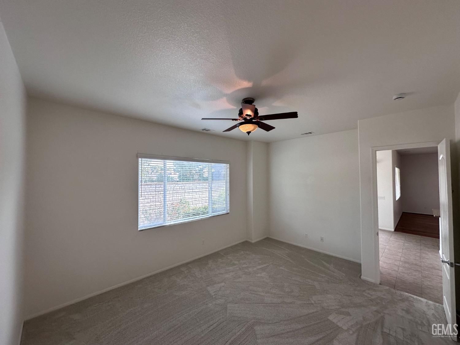 Undisclosed Address Bakersfield, CA 93306 - Photo 37 of 43 an empty room with windows and fan