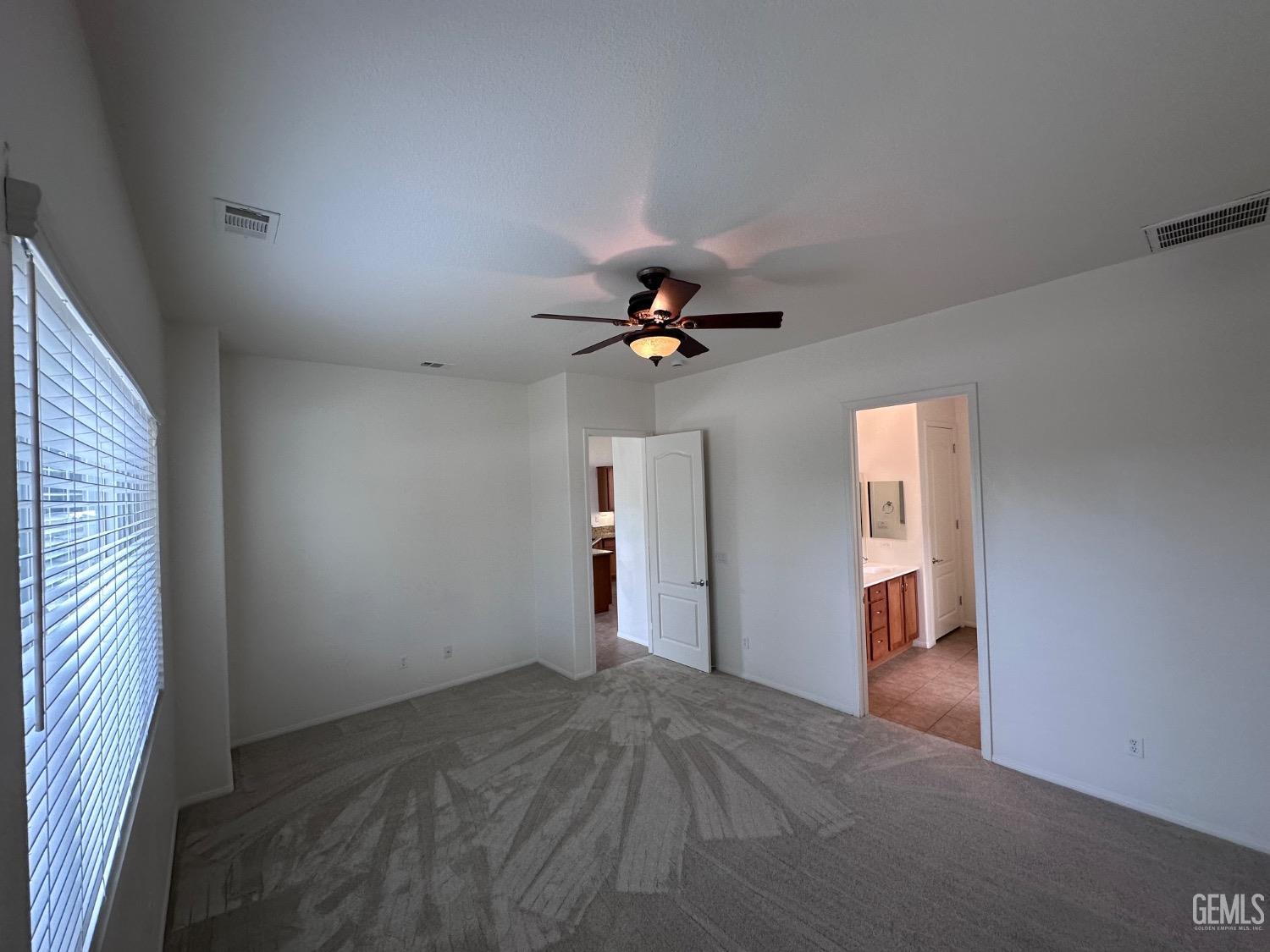 Undisclosed Address Bakersfield, CA 93306 - Photo 38 of 43 a view of a livingroom with a ceiling fan and window
