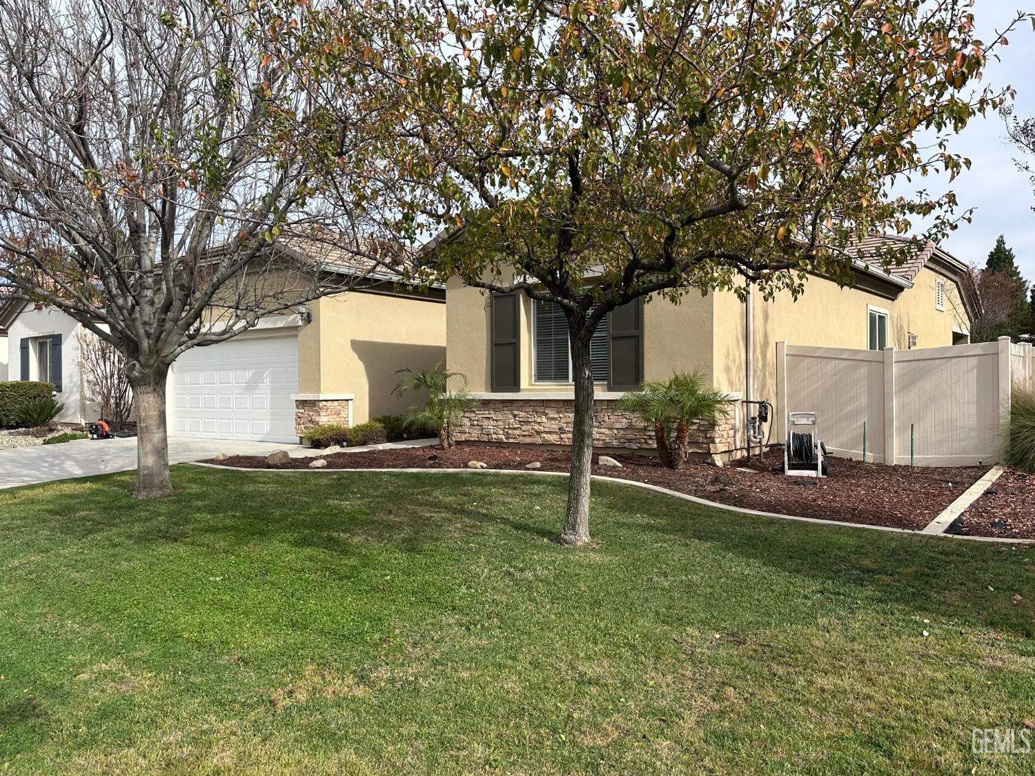 Undisclosed Address Bakersfield, CA 93306 - Photo 4 of 43 a front view of house with yard and tree