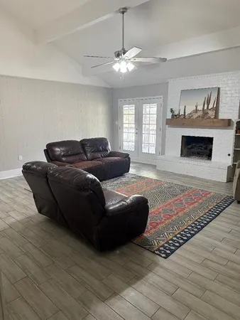 a living room with furniture and a fireplace