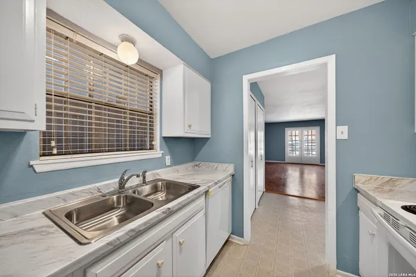 a kitchen that has a sink and a stove