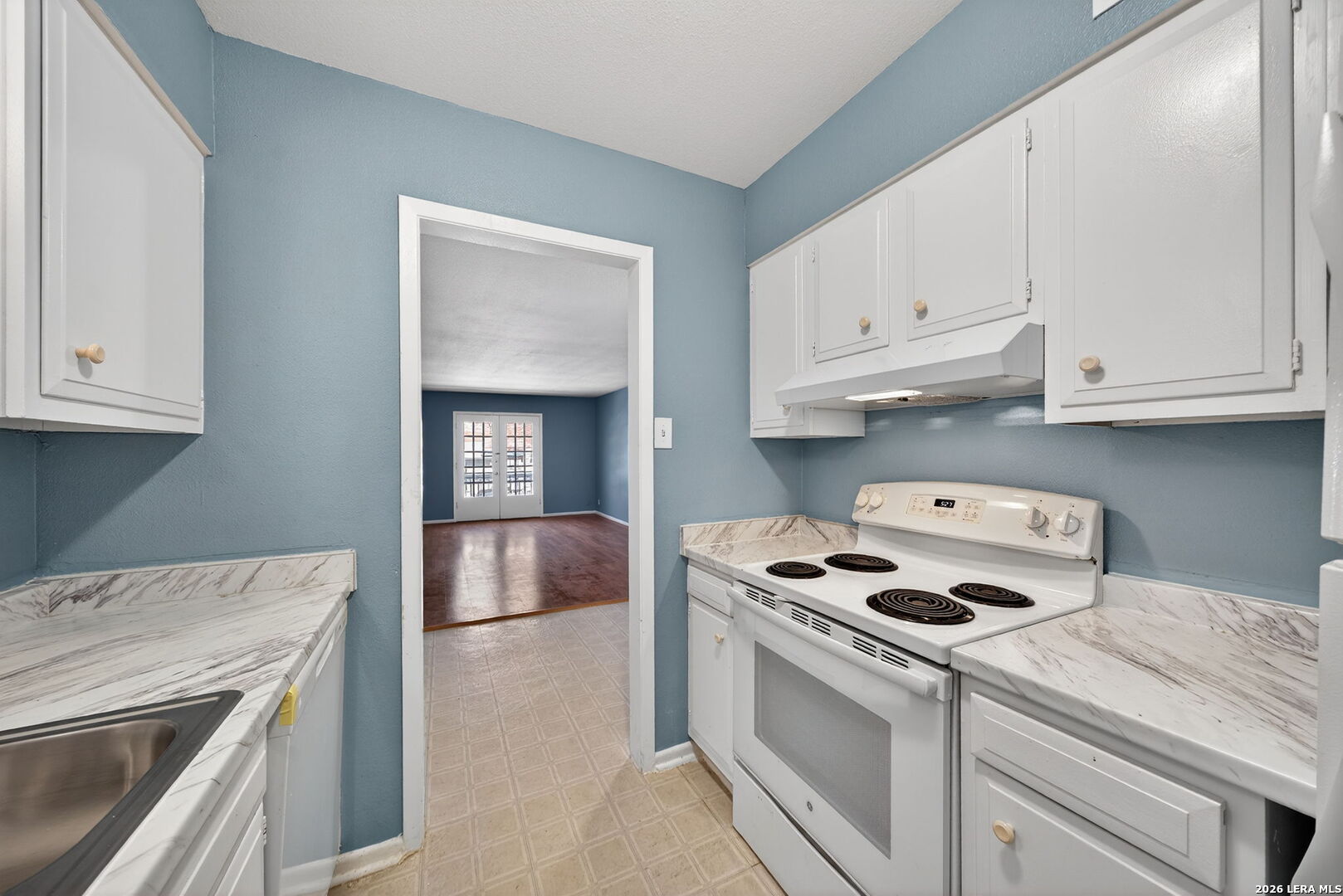 6718 Callaghan Road, Unit 315 San Antonio, TX 78229 - Photo 12 of 27 a kitchen with granite countertop a stove a sink and a refrigerator