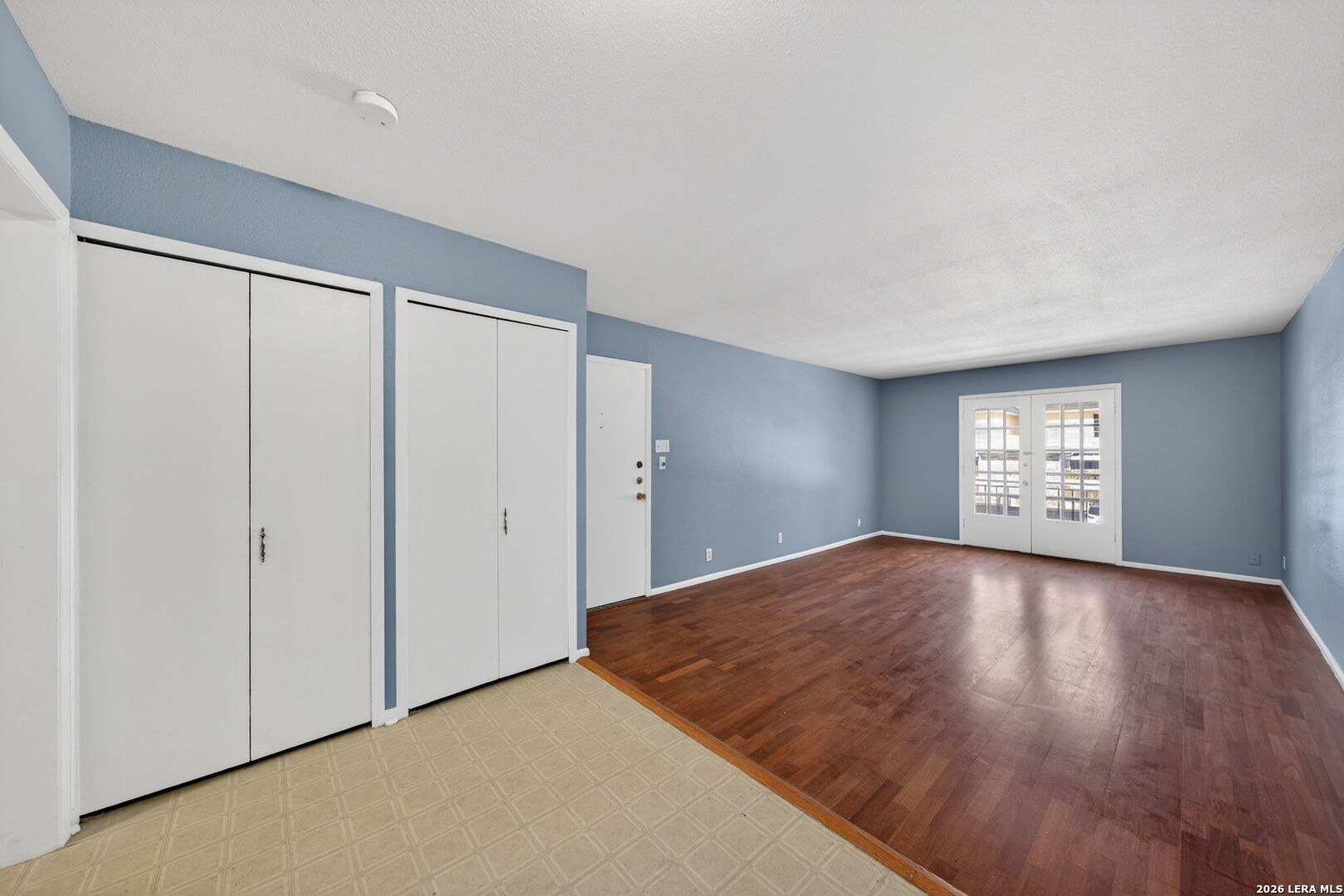 6718 Callaghan Road, Unit 315 San Antonio, TX 78229 - Photo 16 of 27 a view of an empty room with a window and wooden floor
