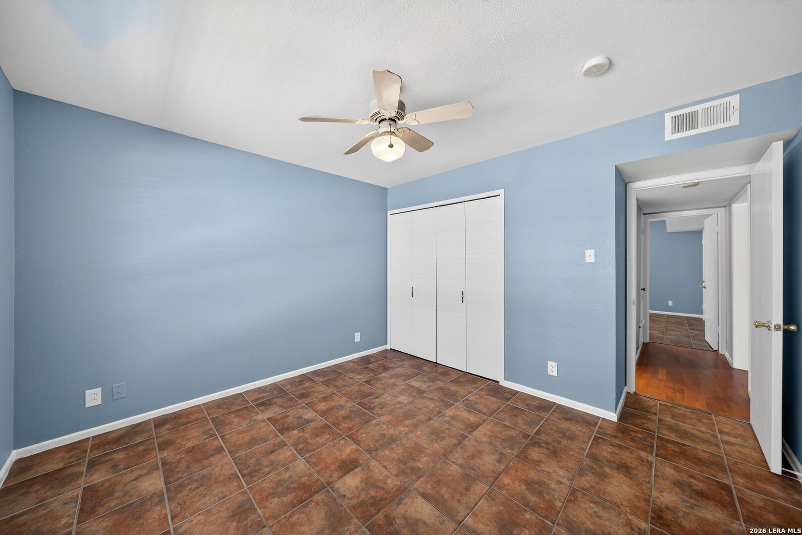 6718 Callaghan Road, Unit 315 San Antonio, TX 78229 - Photo 23 of 27 an empty room with closet and a ceiling fan