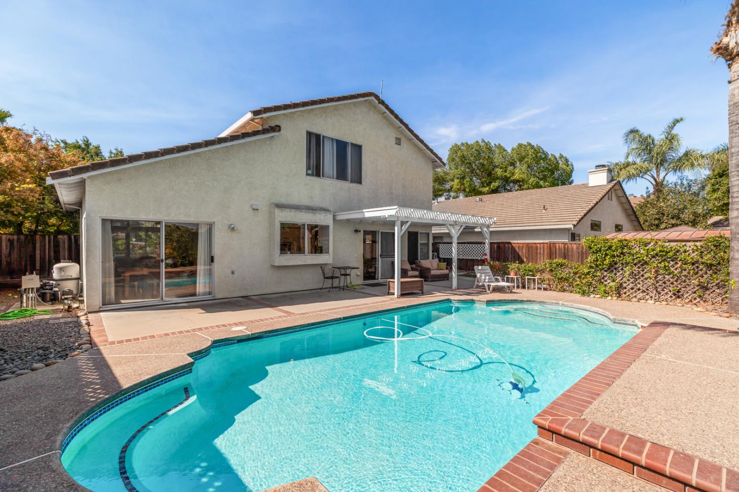 a front view of a house with swimming pool having outdoor seating