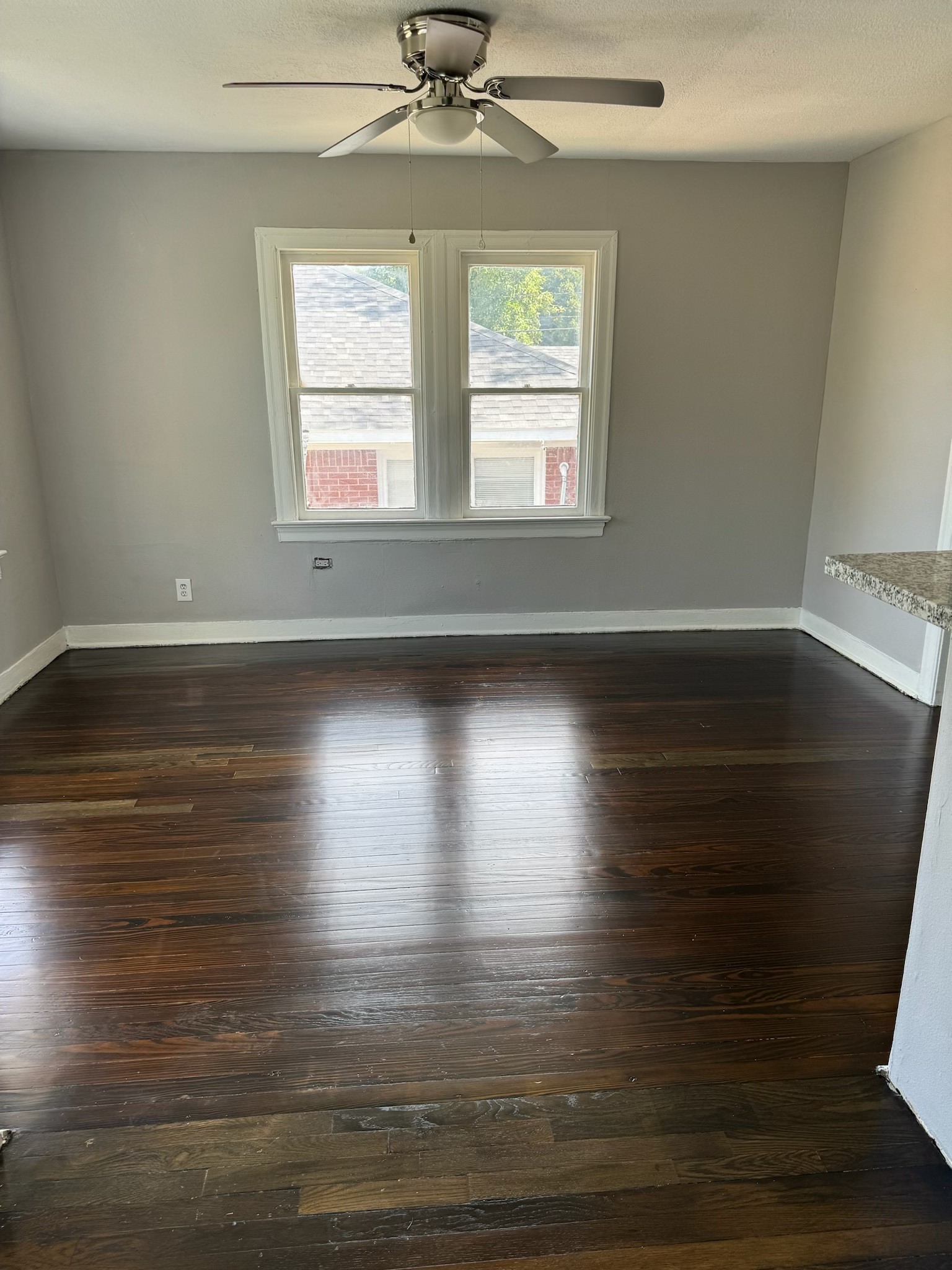 136 1/2 Glendale Street Houston, TX 77012 - Photo 4 of 8 a view of empty room with wooden floor and fan