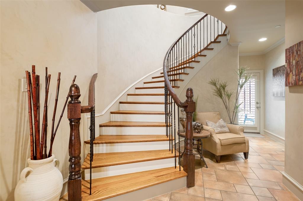 Sweeping staircase to the 2nd level with extra storage under the stairs.