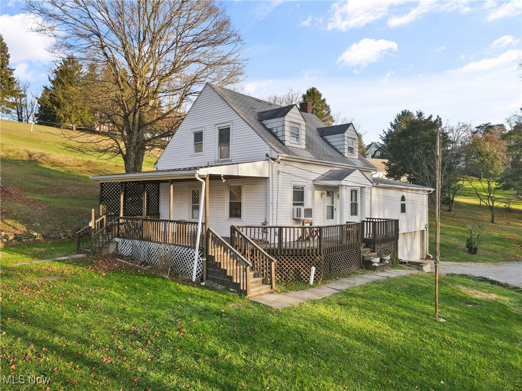 102 Potrock Road Wellsburg, WV 26070 - Photo 2 of 42 View of front of home featuring a front yard, a chimney, stairs, and a deck
