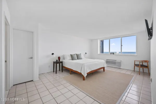 a bathroom with a granite countertop toilet sink and mirror