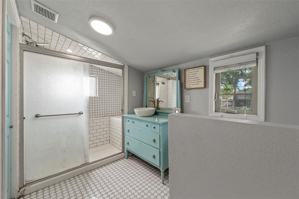 2530 Colcord Avenue Waco, TX 76707 - Photo 16 of 23 Full bath featuring a stall shower, vanity, and a textured ceiling