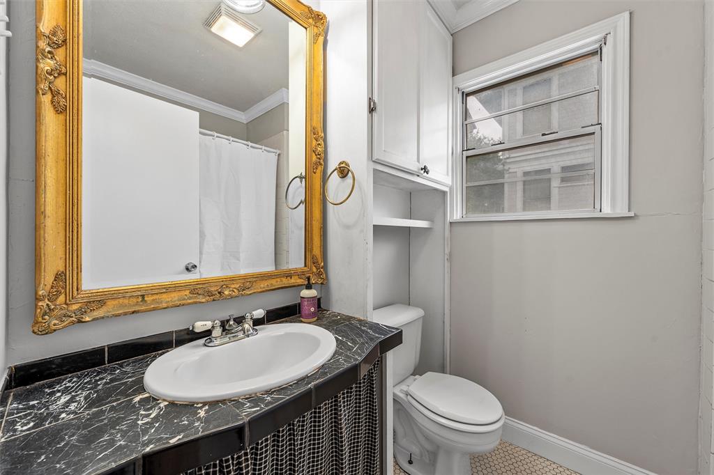 2530 Colcord Avenue Waco, TX 76707 - Photo 17 of 23 Full bathroom with crown molding, toilet, vanity, and tile patterned floors