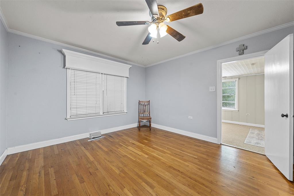 2530 Colcord Avenue Waco, TX 76707 - Photo 20 of 23 Empty room featuring wood-type flooring, ornamental molding, ceiling fan, and baseboards