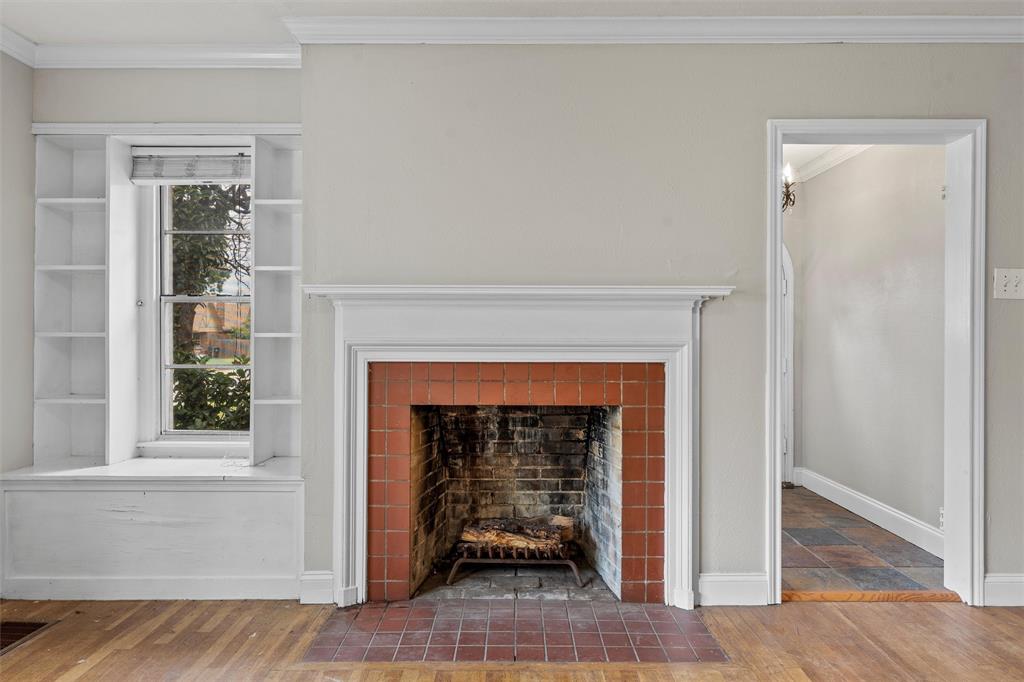 2530 Colcord Avenue Waco, TX 76707 - Photo 7 of 23 Detailed view of a tile fireplace, crown molding, wood finished floors, and baseboards