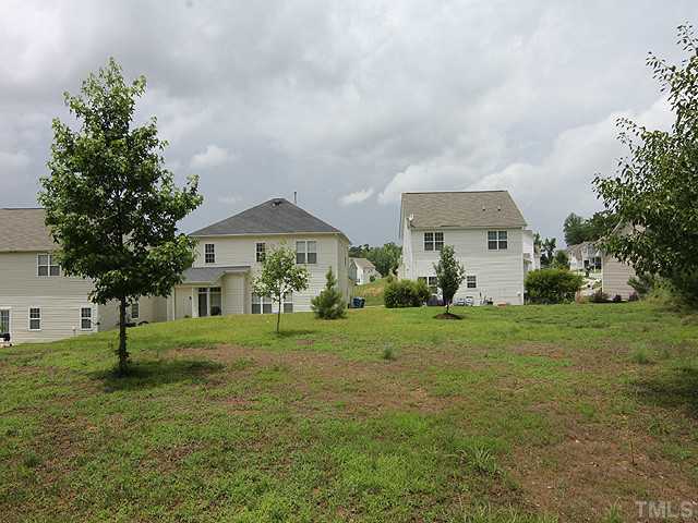 678 Citrus Petal Road Fuquay-Varina, NC 27526 - Photo 10 of 14 a view of an house with backyard space and garden