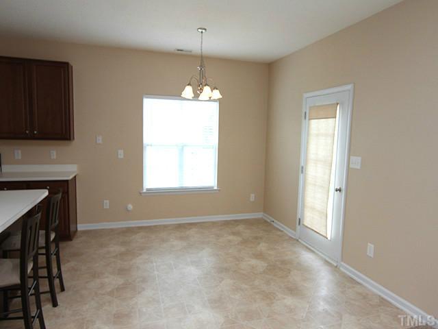 678 Citrus Petal Road Fuquay-Varina, NC 27526 - Photo 4 of 14 a view of livingroom with chandelier fan and windows