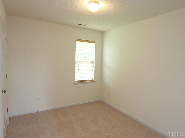678 Citrus Petal Road Fuquay-Varina, NC 27526 - Photo 8 of 14 an empty room with a window