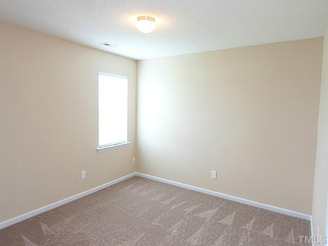 678 Citrus Petal Road Fuquay-Varina, NC 27526 - Photo 9 of 14 an empty room with a window