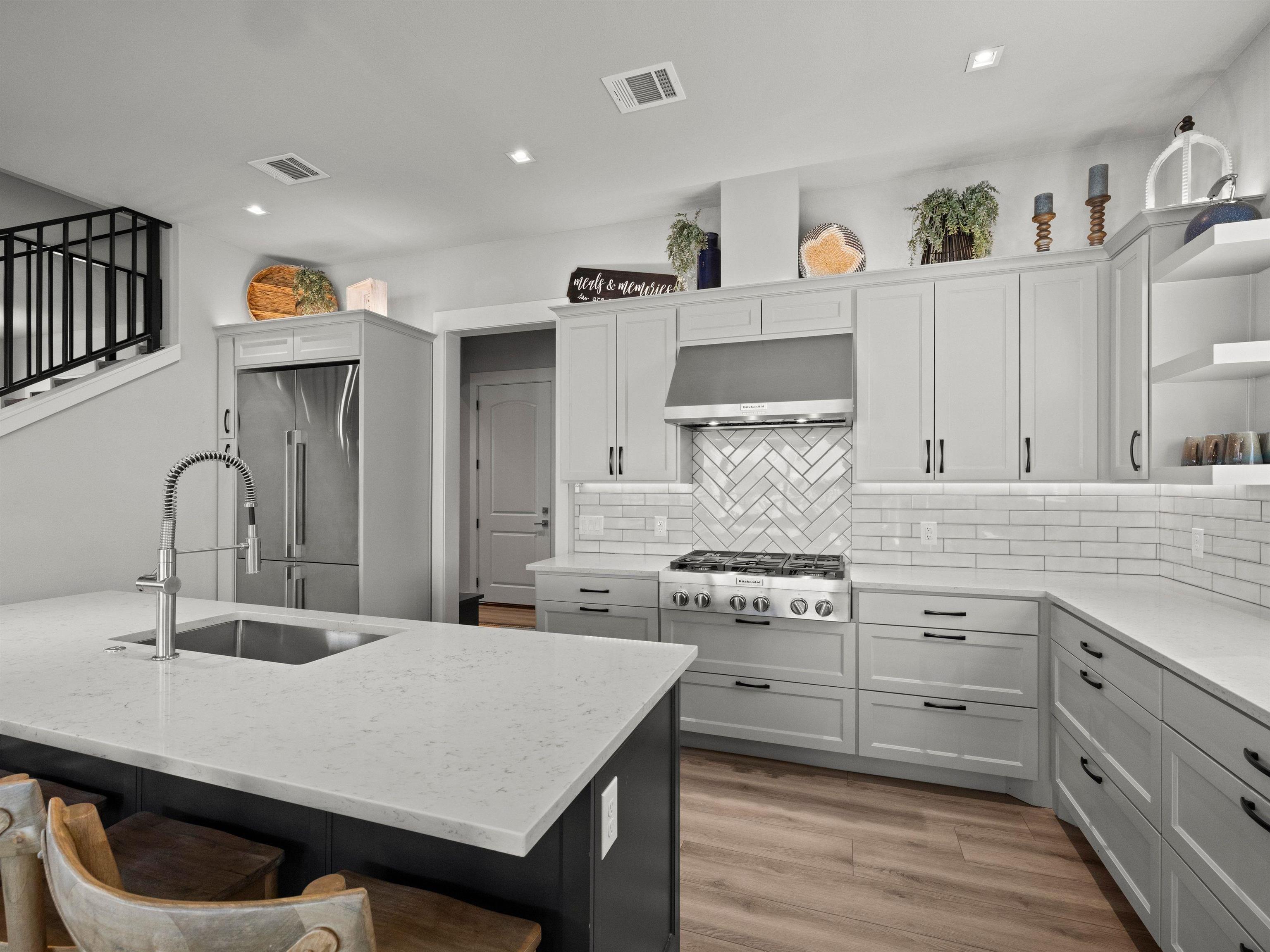 200 Archview Lane Kingsland, TX 78639 - Photo 11 of 45 a kitchen with stainless steel appliances granite countertop a stove a sink and a refrigerator