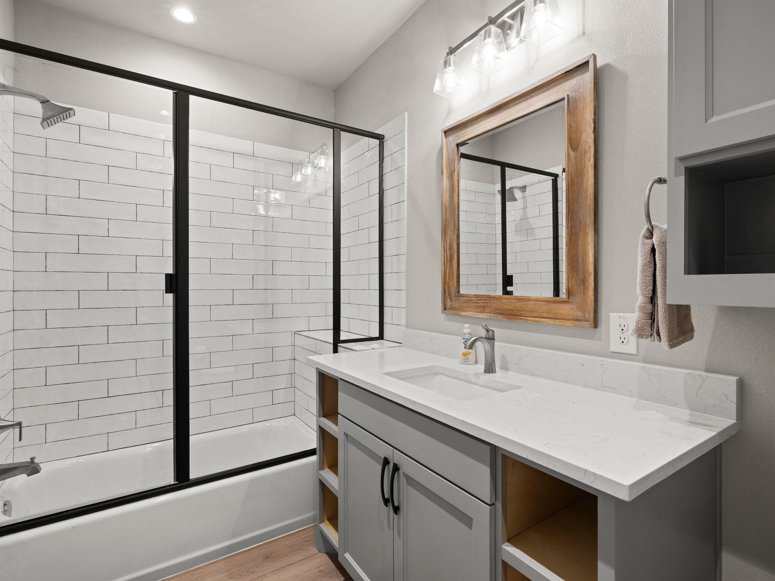 200 Archview Lane Kingsland, TX 78639 - Photo 15 of 45 a bathroom with a sink a large mirror and shower