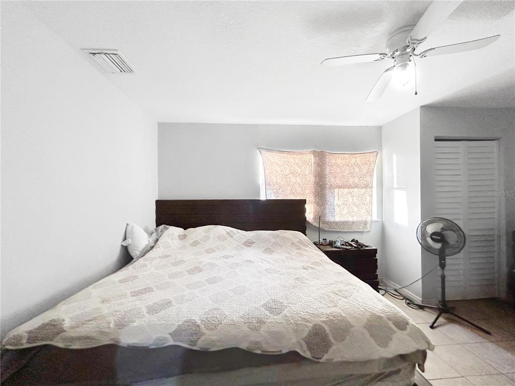 17447 Bathurst Avenue Spring Hill, FL 34610 - Photo 11 of 19 a bedroom with a bed and window