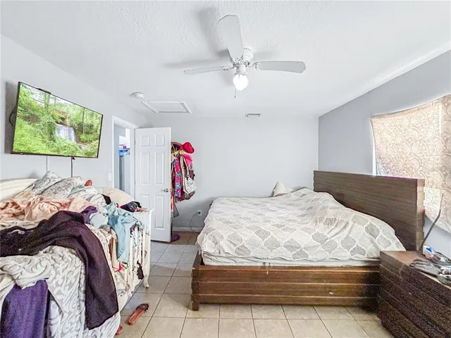 a bedroom with two beds and a chandelier