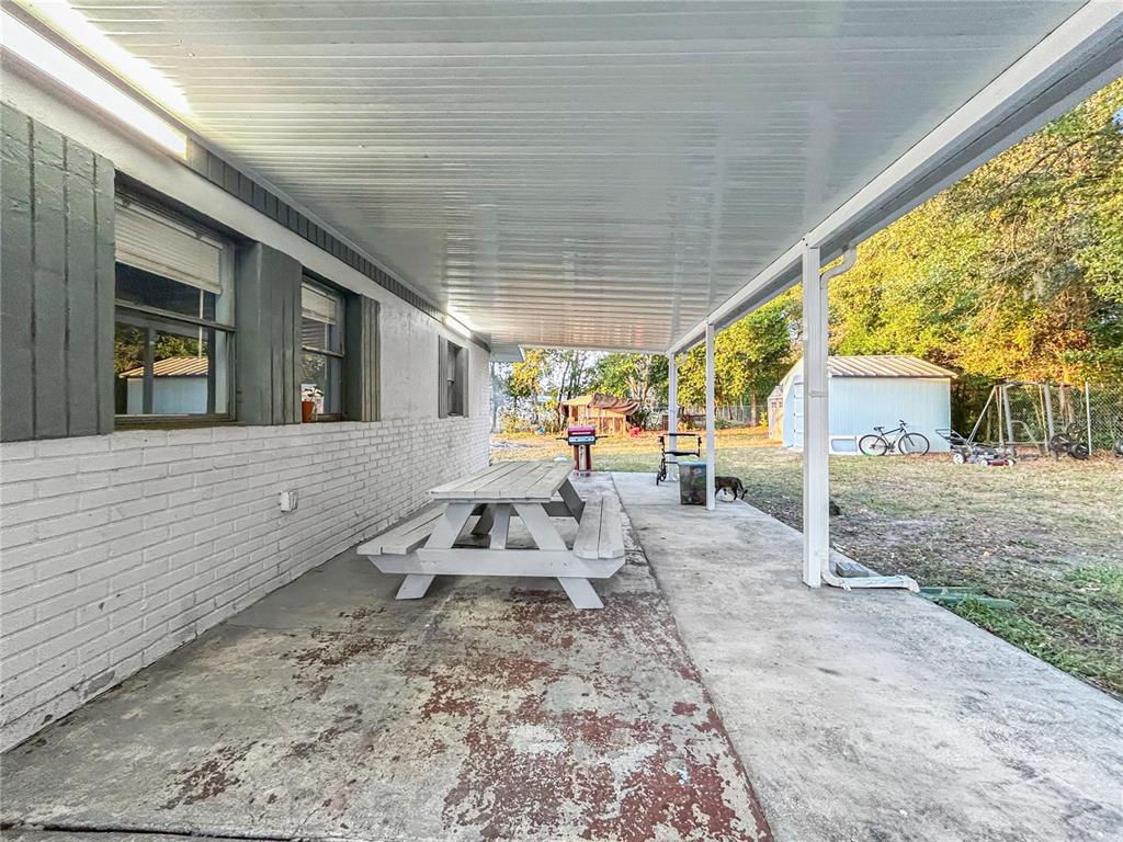 17447 Bathurst Avenue Spring Hill, FL 34610 - Photo 16 of 19 a view of a house with backyard and sitting area
