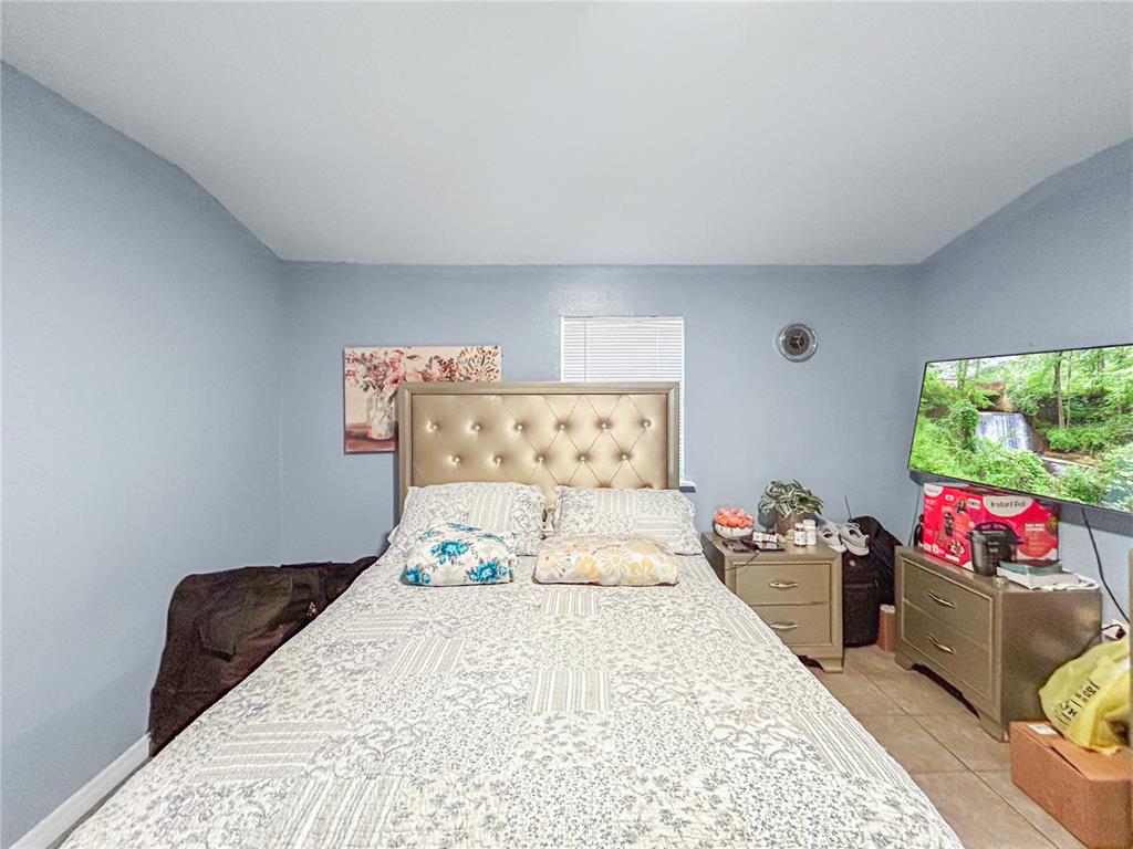 17447 Bathurst Avenue Spring Hill, FL 34610 - Photo 5 of 19 a bedroom with a bed and a couch