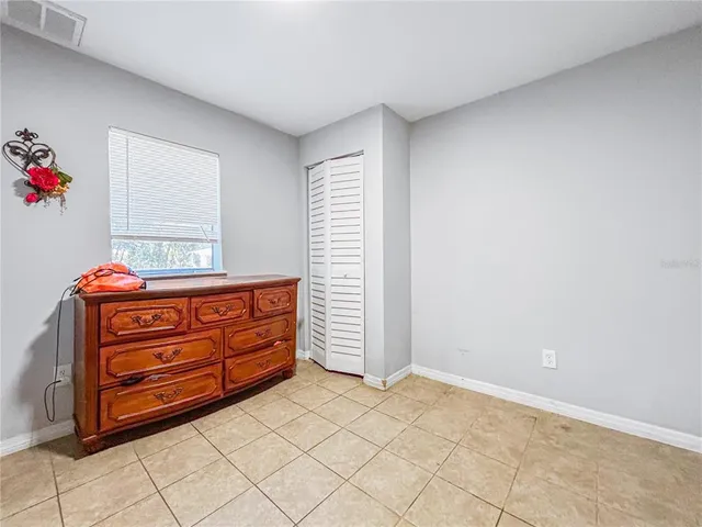 a room with a dresser and a window