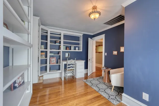 an empty room with windows and cabinet