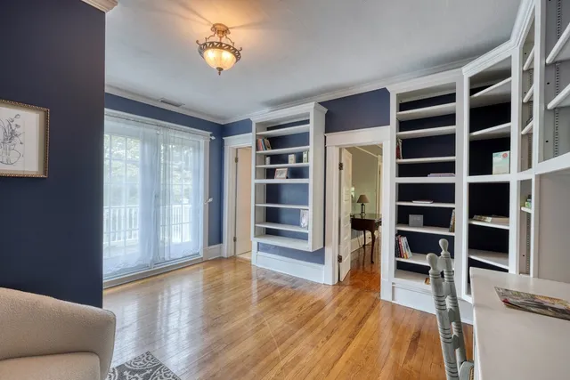 a view of a deck with a bench and floor to ceiling window