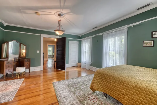 a backyard of a house with wooden fence and potted plants
