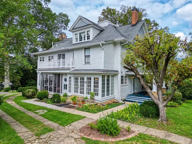 a front view of a house with a garden and plants