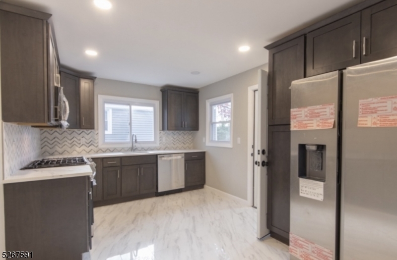 a large kitchen with cabinets and stainless steel appliances