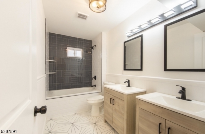 35 Watson Avenue, Unit 2 West Orange, NJ 07052 - Photo 5 of 6 a bathroom with a sink a toilet and shower